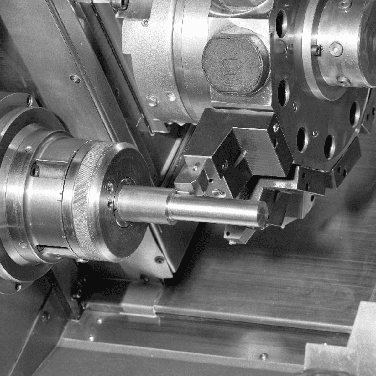Five-axis CNC machining of a complex metal component with angled tool access