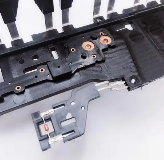 Finished plastic component molded around a metal insert